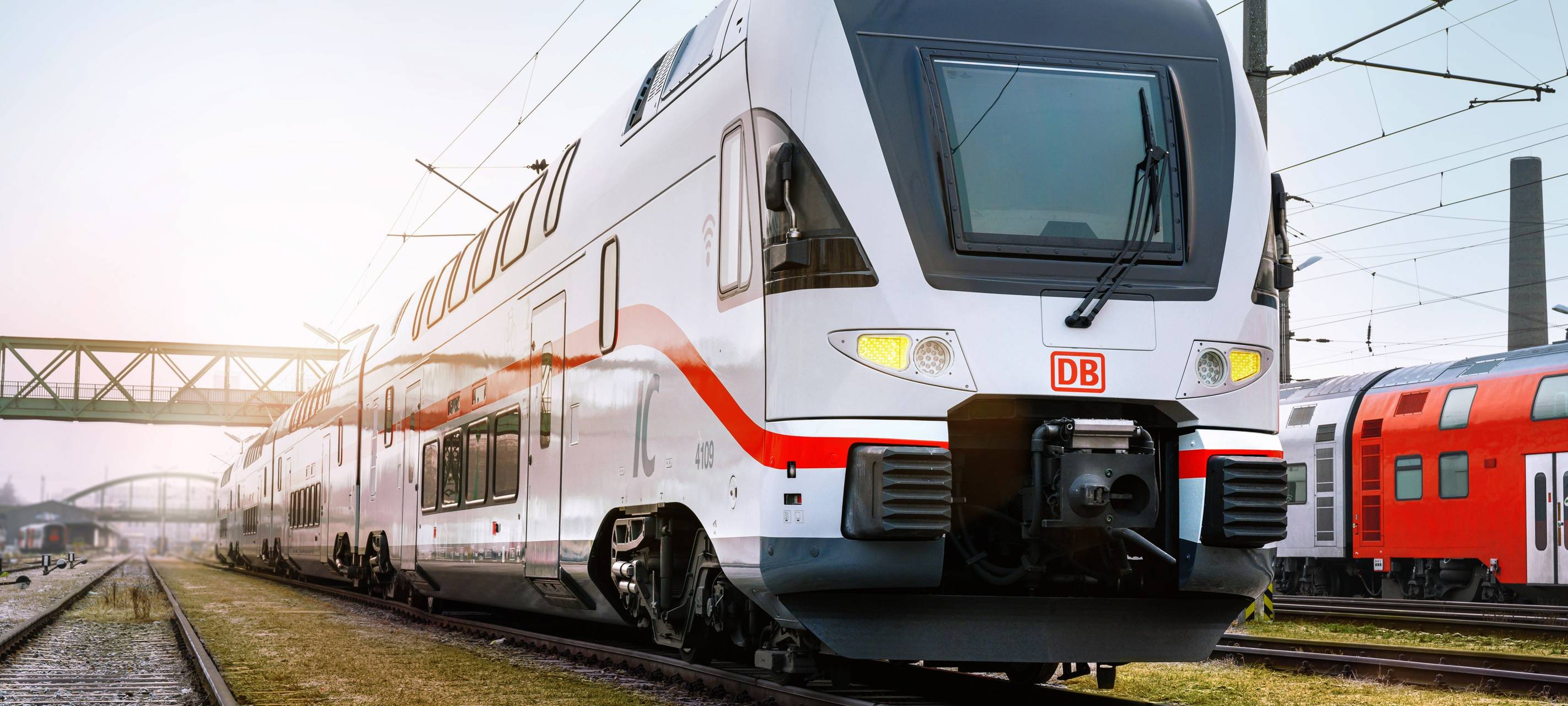 Ein Intercity der Deutschen Bahn fährt durch eine grüne Landschaft.